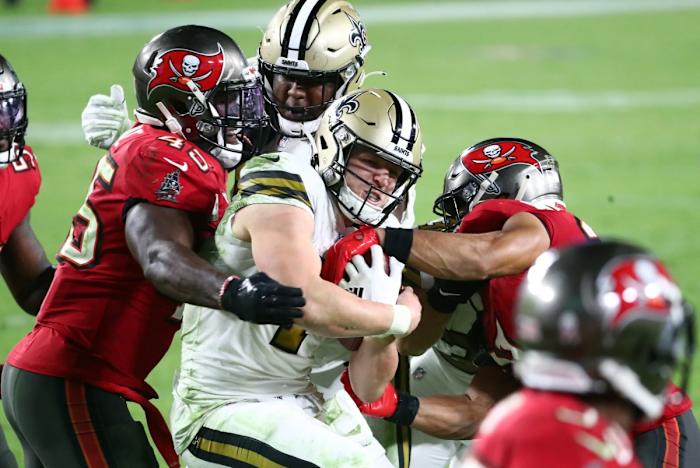 New Orleans Saints Taysom Hill (7) is stopped by Tampa Bay Buccaneers linebacker Devin White (45). Mandatory Credit: Kim Klement-USA TODAY